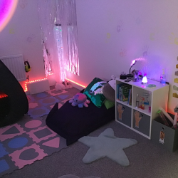 photo of sensory space. Including sensory lighting, soft rug and cushions. Blackout tent,